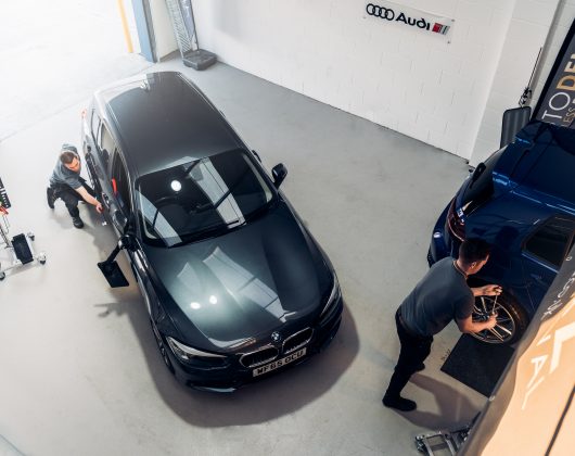 Jason and Paul from AutoDentz Ltd repairing card dents in their Plymouth workshop